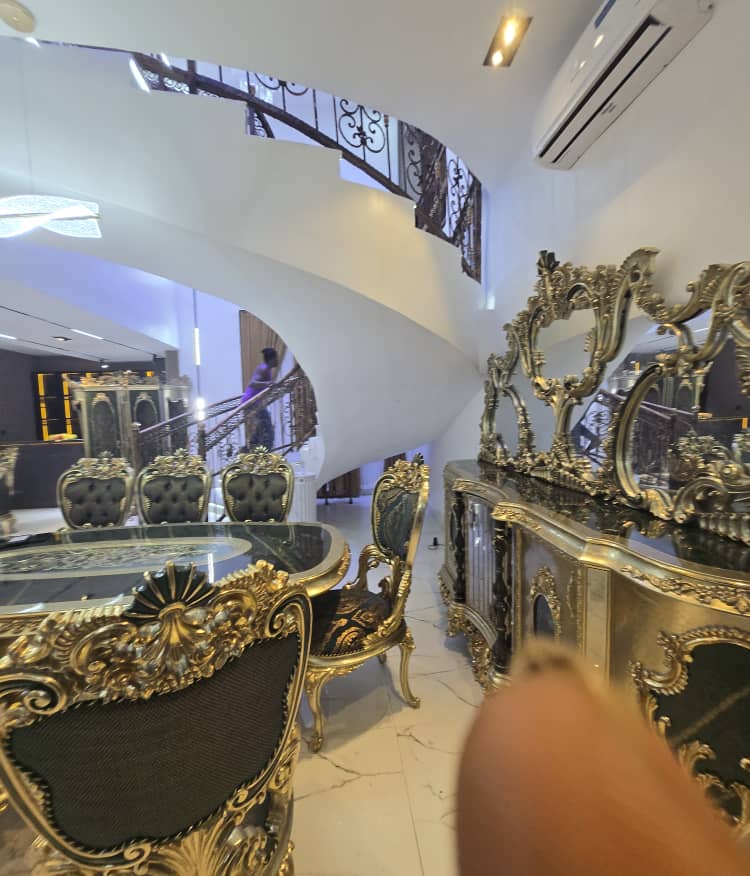 Luxury dining room with ornate dining suite and statement mirrors